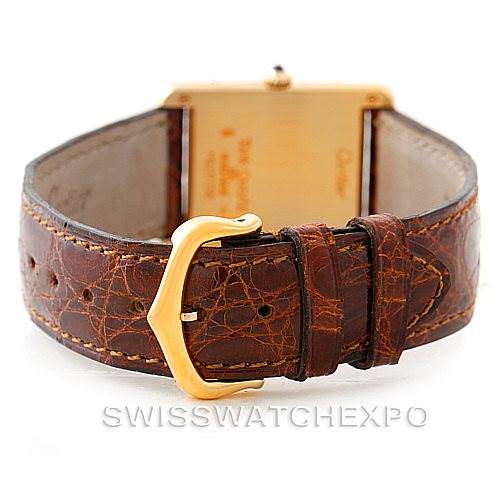 The image shows the back view of a Cartier Tank Classic Men's Yellow Gold Silver Dial Men's Yellow Gold Silver Dial watch, highlighting its leather strap and gold-tone buckle.