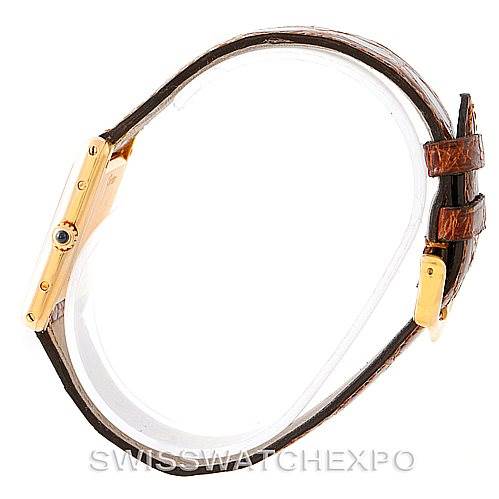 The image shows a side angle of the Cartier Tank Classic Men's Yellow Gold Silver Dial Men's Yellow Gold Silver Dial watch highlighting its gold casing and brown leather strap.