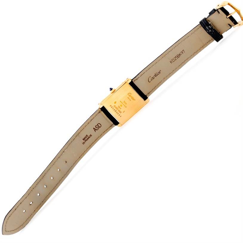 The image shows the back view of a Cartier Tank Classic Men's Yellow Gold Beige Dial Men's Yellow Gold Beige Dial watch, displaying the case back and leather strap.