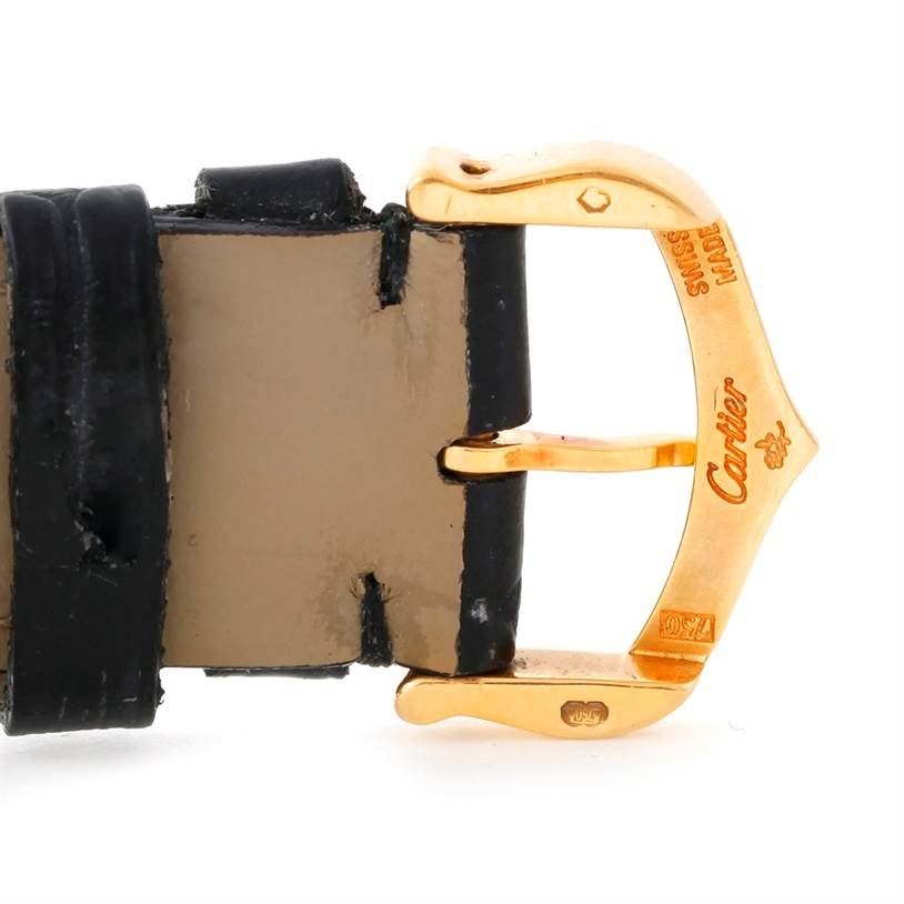 This image shows the gold-toned buckle and part of the leather strap of a Cartier Tank Classic Men's Yellow Gold Beige Dial Men's Yellow Gold Beige Dial watch.