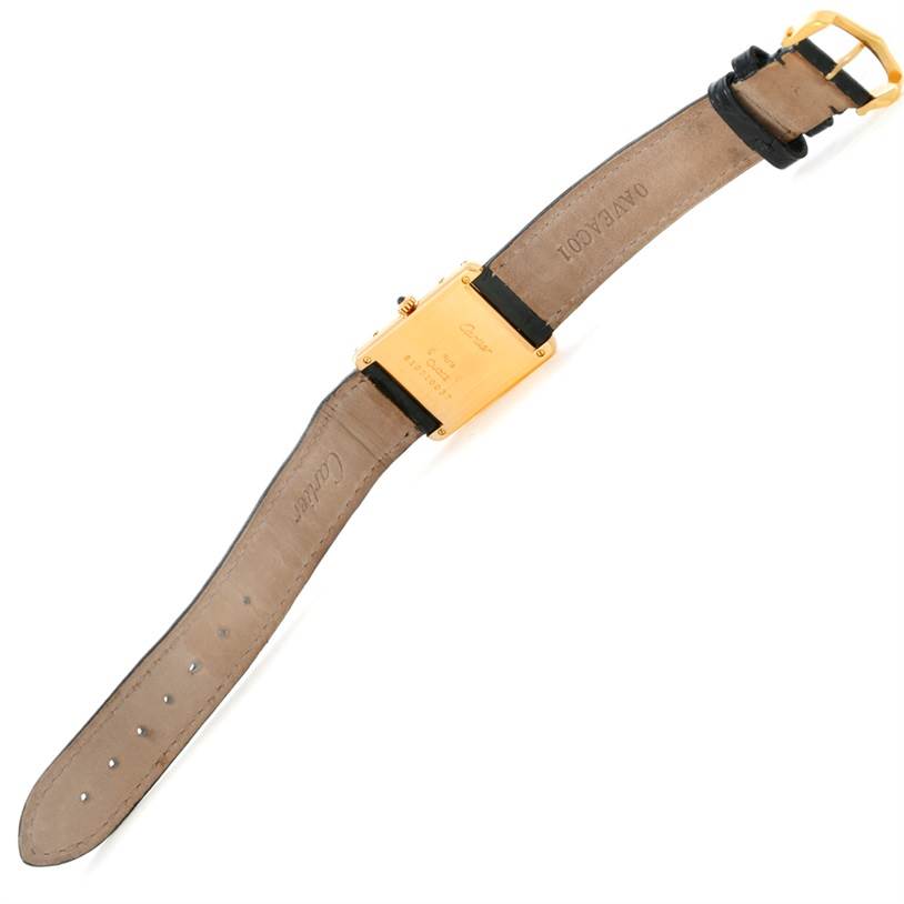 The image shows the back view of the Tank Classic model by Cartier, including its leather straps and gold case.