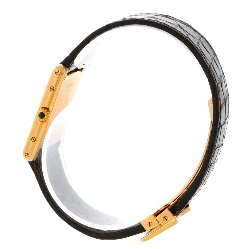 The image shows a side view of the Cartier Tank Classic 810521619 Yellow Gold White Dial 810521619 Yellow Gold White Dial watch, focusing on the gold case and leather strap.