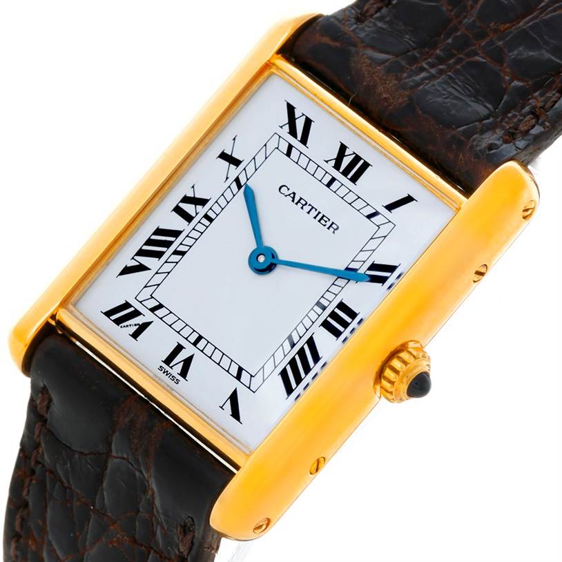 The image shows a Cartier Tank Classic 810521619 Yellow Gold White Dial 810521619 Yellow Gold White Dial watch at an angled close-up, displaying the face, crown, and part of the leather strap.