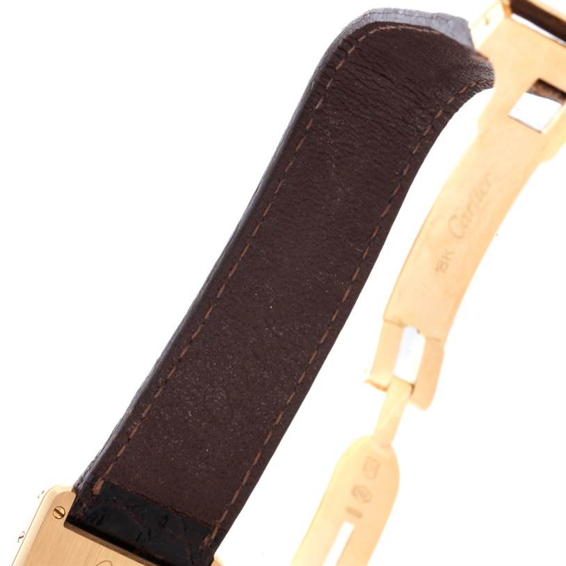 The image shows a close-up of the strap and clasp of a Cartier Tank Classic 810521619 Yellow Gold White Dial 810521619 Yellow Gold White Dial watch at an oblique angle.