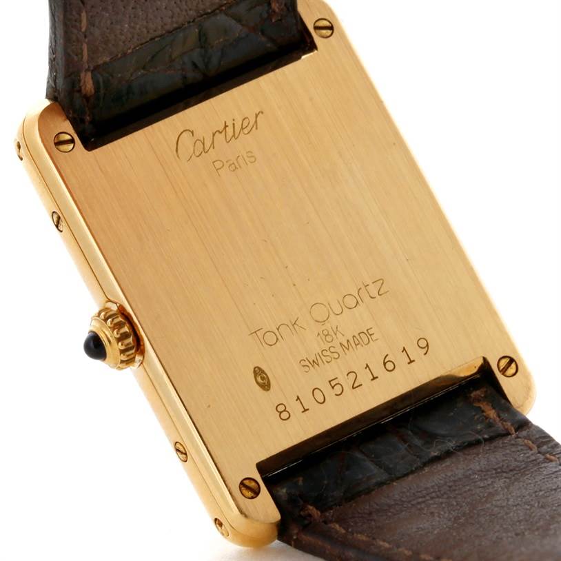 This image shows the back case and part of the leather strap of the Cartier Tank Classic 810521619 Yellow Gold White Dial 810521619 Yellow Gold White Dial watch.