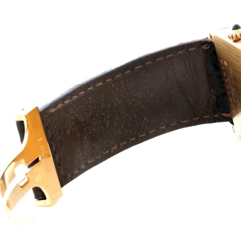 The image shows a close-up view of the strap and clasp of a Cartier Tank Classic 810521619 Yellow Gold White Dial 810521619 Yellow Gold White Dial watch.