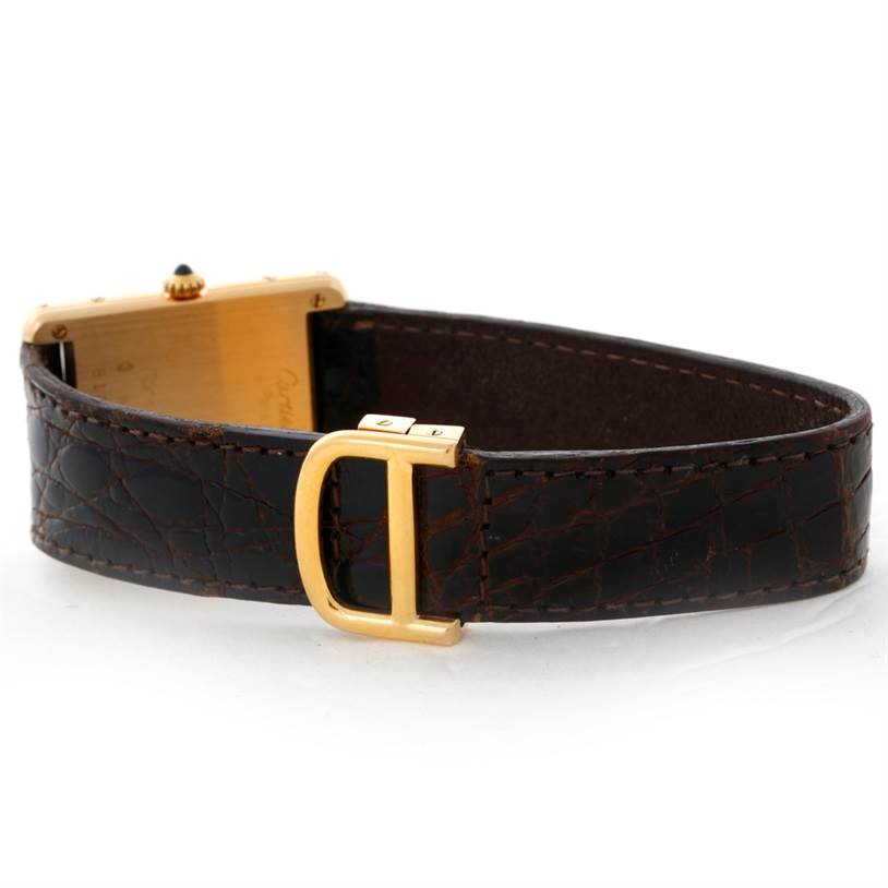 The image shows the side and clasp of a Cartier Tank Classic 810521619 Yellow Gold White Dial 810521619 Yellow Gold White Dial watch with a brown leather strap and a gold buckle.