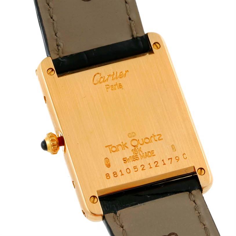 The image shows the back case of a Cartier Tank Classic Men's Yellow Gold White Dial Men's Yellow Gold White Dial watch, highlighting the brand, model, and serial number.
