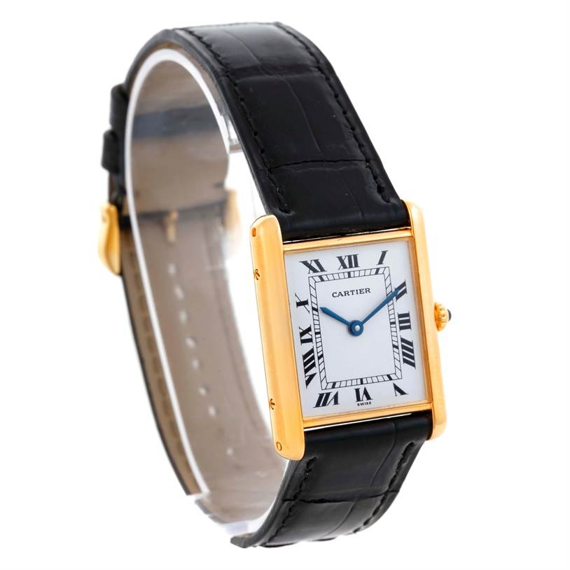 The image shows a Cartier Tank Classic Men's Yellow Gold White Dial Men's Yellow Gold White Dial watch at a three-quarter angle, displaying its face, gold case, black leather strap, and crown.
