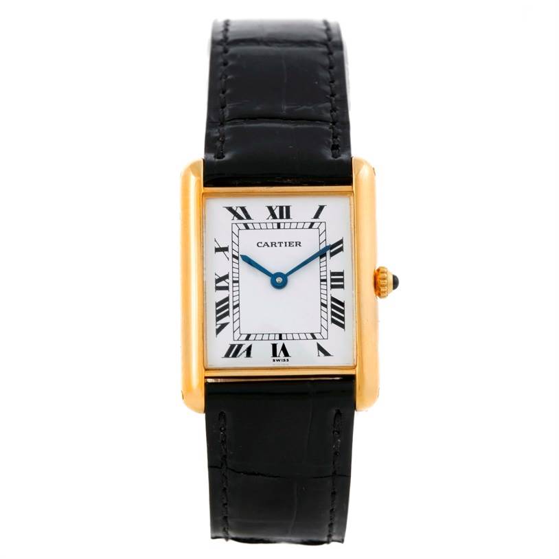 The Cartier Tank Classic Men's Yellow Gold White Dial Men's Yellow Gold White Dial watch is shown from a front angle, highlighting the face, Roman numerals, and black strap.