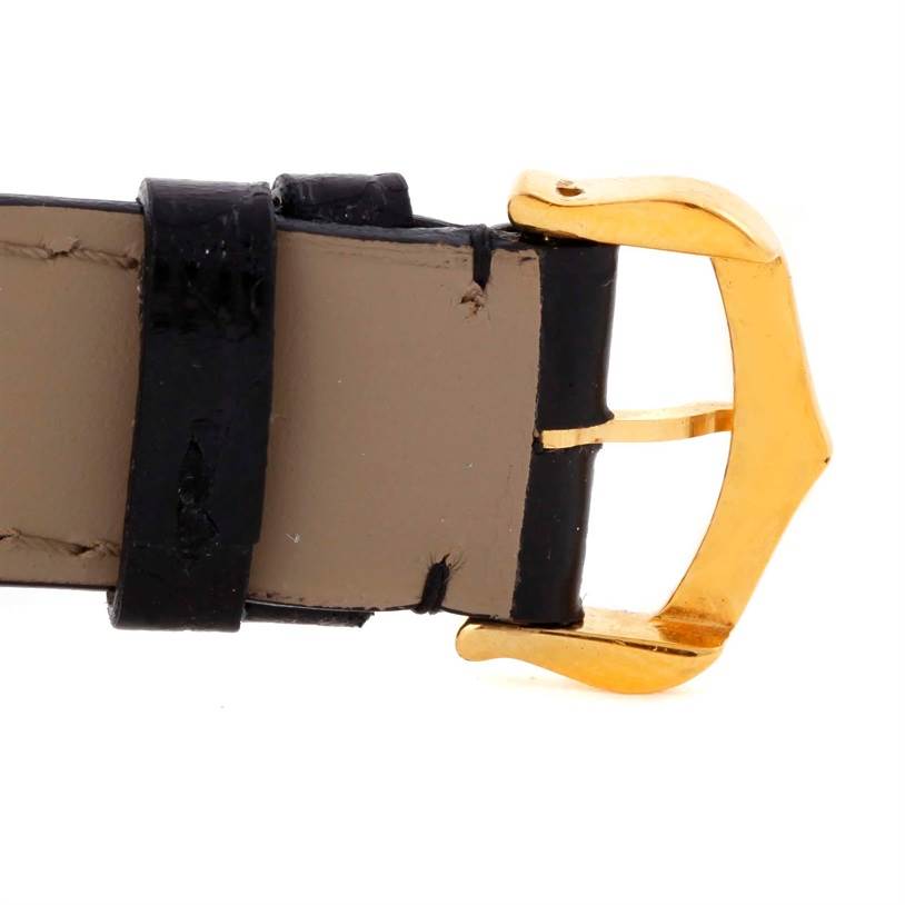 This image shows a close-up view of the buckle and leather strap of a Cartier Tank Classic Men's Yellow Gold White Dial Men's Yellow Gold White Dial watch.