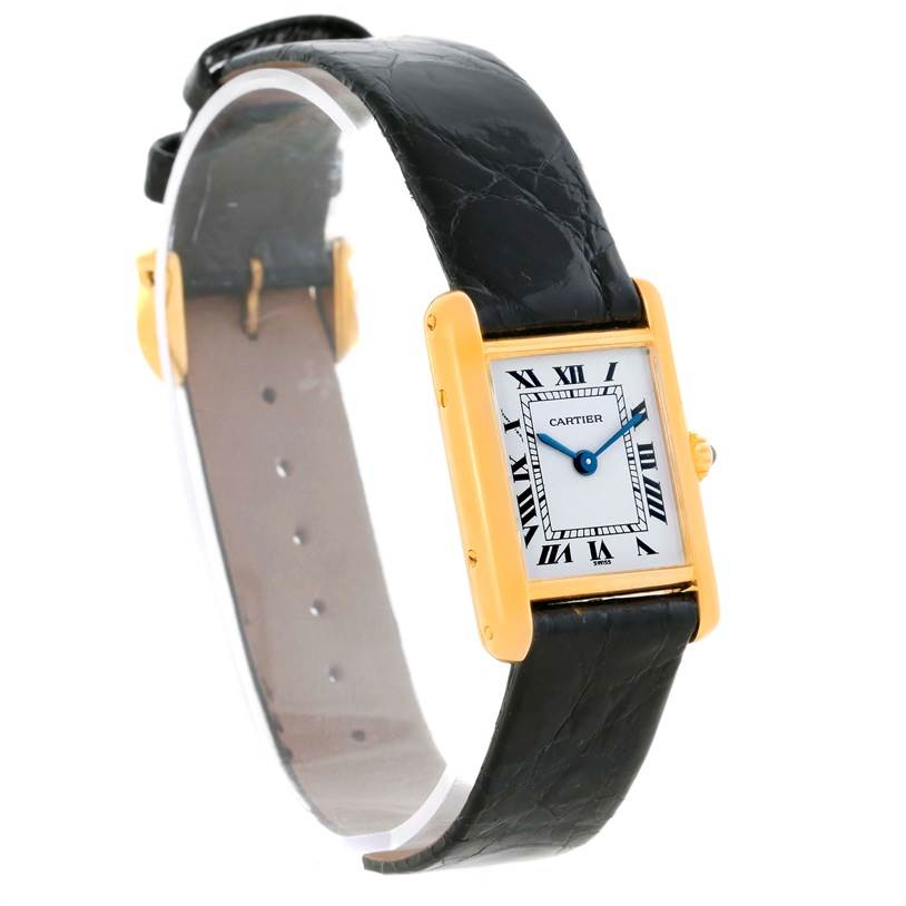 This image shows a frontal and slightly angled view of the Cartier Tank Classic Women's Yellow Gold White Dial Women's Yellow Gold White Dial watch with its black leather strap and rectangular gold case.