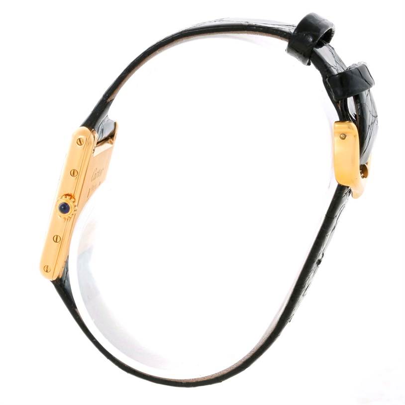 The image shows a side view of a Cartier Tank Classic Women's Yellow Gold White Dial Women's Yellow Gold White Dial watch, highlighting the crown and strap.