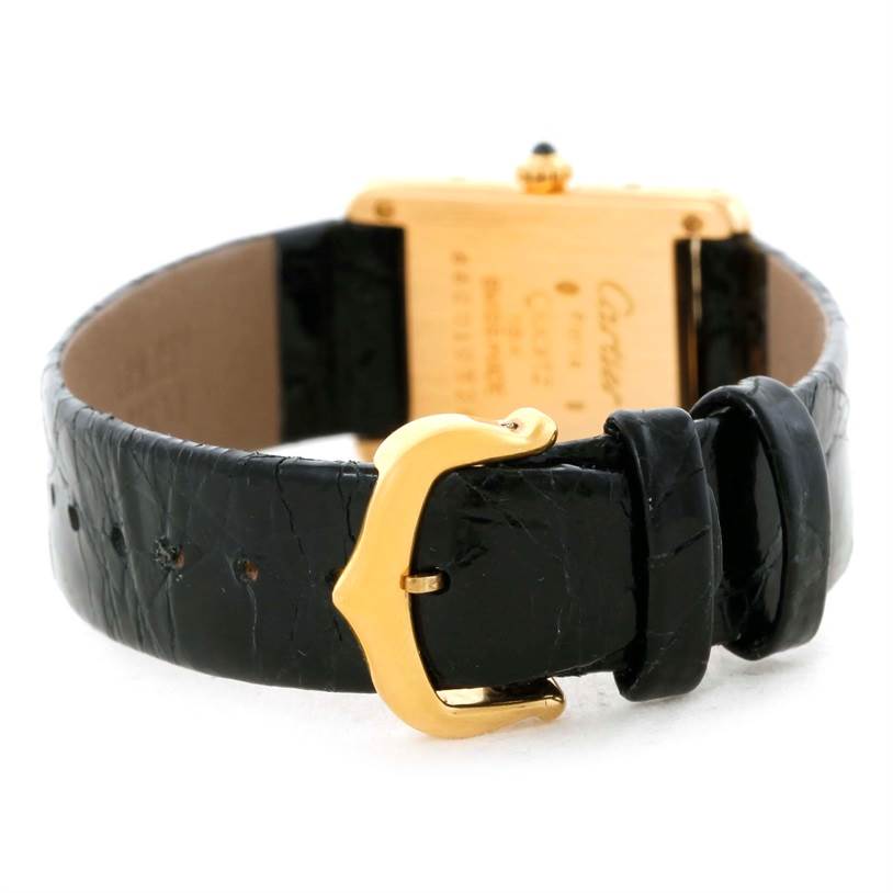 The image shows the back view of a Cartier Tank Classic Women's Yellow Gold White Dial Women's Yellow Gold White Dial watch, focusing on the leather strap and gold buckle.