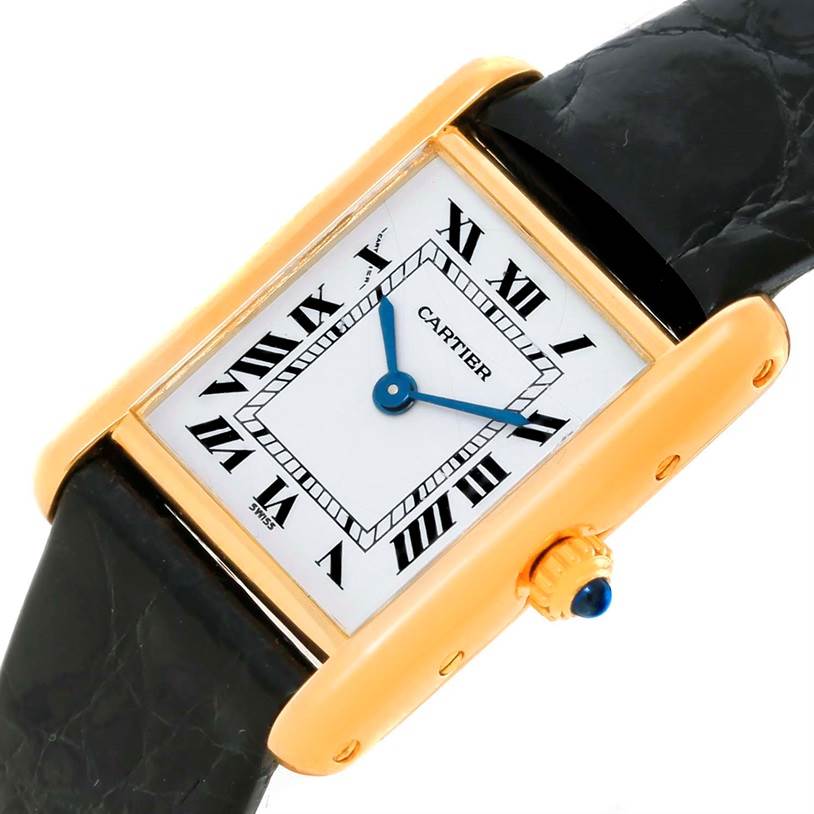 The Cartier Tank Classic Women's Yellow Gold White Dial Women's Yellow Gold White Dial watch is shown at a slight angle, featuring its rectangular face, Roman numerals, and a black leather strap.