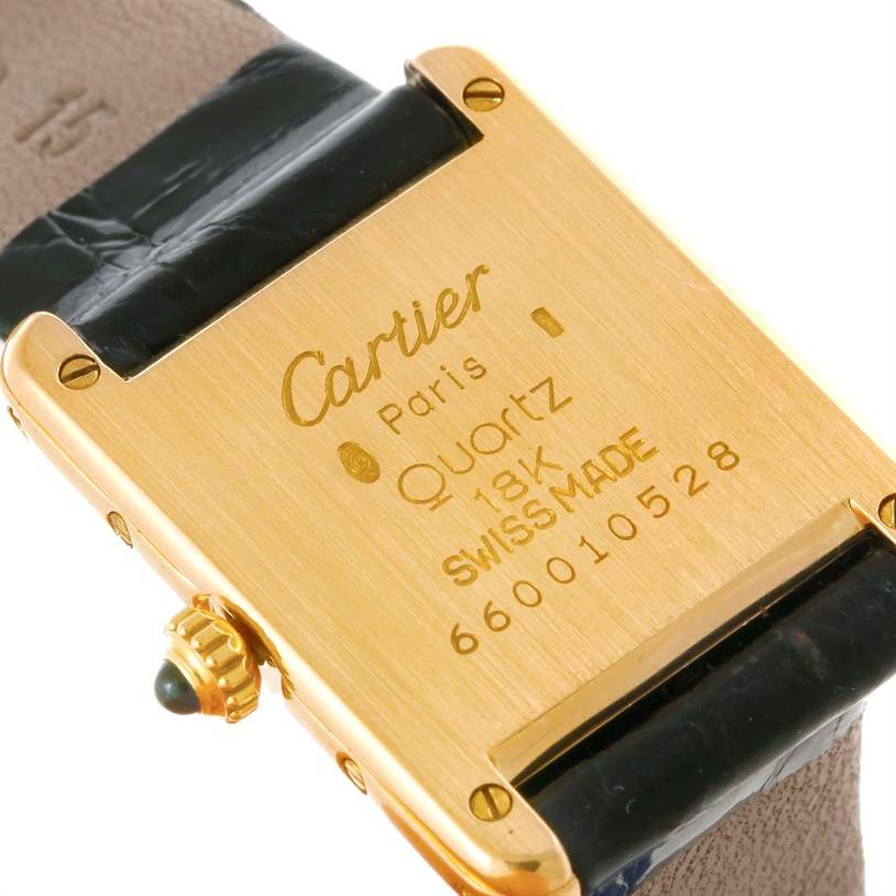 The image shows the back of a Cartier Tank Classic Women's Yellow Gold White Dial Women's Yellow Gold White Dial watch, highlighting its gold case, model details, and strap connection.