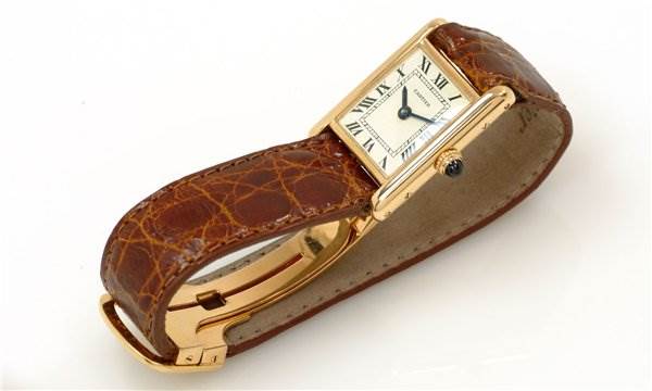 This image shows a close-up of the Cartier Tank Classic Women's Yellow Gold White Dial Women's Yellow Gold White Dial model watch, highlighting the face, leather strap, and buckle.