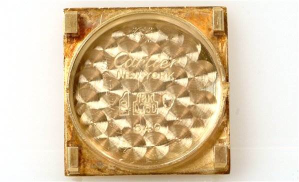 The image shows the interior back casing of a Cartier Tank Classic Women's Yellow Gold White Dial Women's Yellow Gold White Dial watch from a top-down angle.