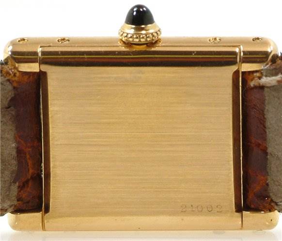 The image shows the back side of a Tank Classic model watch by Cartier, highlighting the case back and the lugs of the watch.