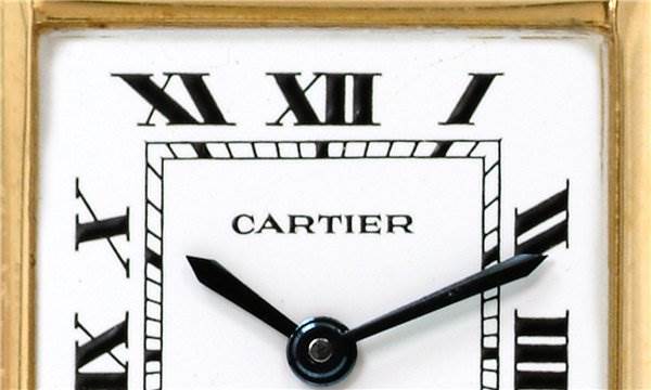 The image shows a close-up of the dial of a Cartier Tank Classic Women's Yellow Gold White Dial Women's Yellow Gold White Dial watch, including the Roman numerals and hands.