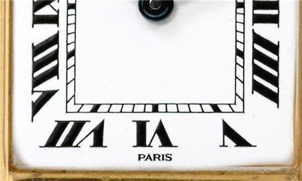 The image shows a close-up of the Cartier Tank Classic Women's Yellow Gold White Dial Women's Yellow Gold White Dial model's dial featuring Roman numerals and the word "Paris."