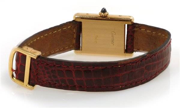 This image shows the back side of a Cartier Tank Classic Women's Yellow Gold White Dial Women's Yellow Gold White Dial watch, highlighting the leather strap and the gold case.