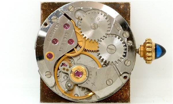 This is a close-up view of the movement mechanism of a Cartier Tank Classic Women's Yellow Gold White Dial Women's Yellow Gold White Dial model watch.