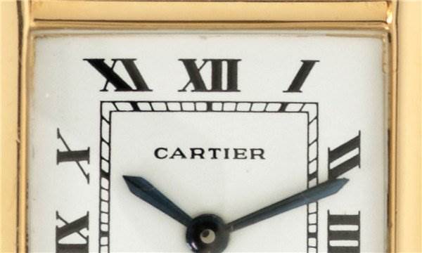 The image shows a close-up of the dial and hands of a Cartier Tank Classic Women's Yellow Gold White Dial Women's Yellow Gold White Dial watch.