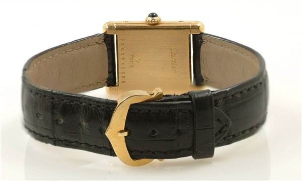 This image shows the rear view of a Cartier Tank Classic Women's Yellow Gold White Dial Women's Yellow Gold White Dial watch, highlighting the back of the watch case and the clasp of the leather strap.