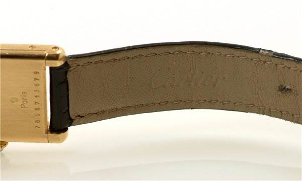 This image shows the underside of the strap and part of the buckle of a Tank Classic model by Cartier from a close-up angle.