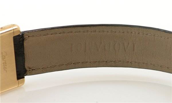 This image shows the underside of the strap and part of the clasp of the Cartier Tank Classic Women's Yellow Gold White Dial Women's Yellow Gold White Dial watch.