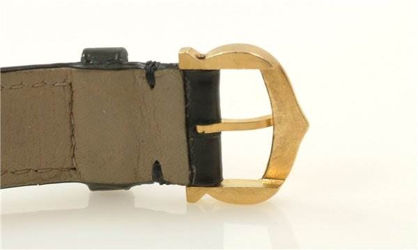 This image shows a close-up side view of the buckle section of the Cartier Tank Classic Women's Yellow Gold White Dial Women's Yellow Gold White Dial watch strap.