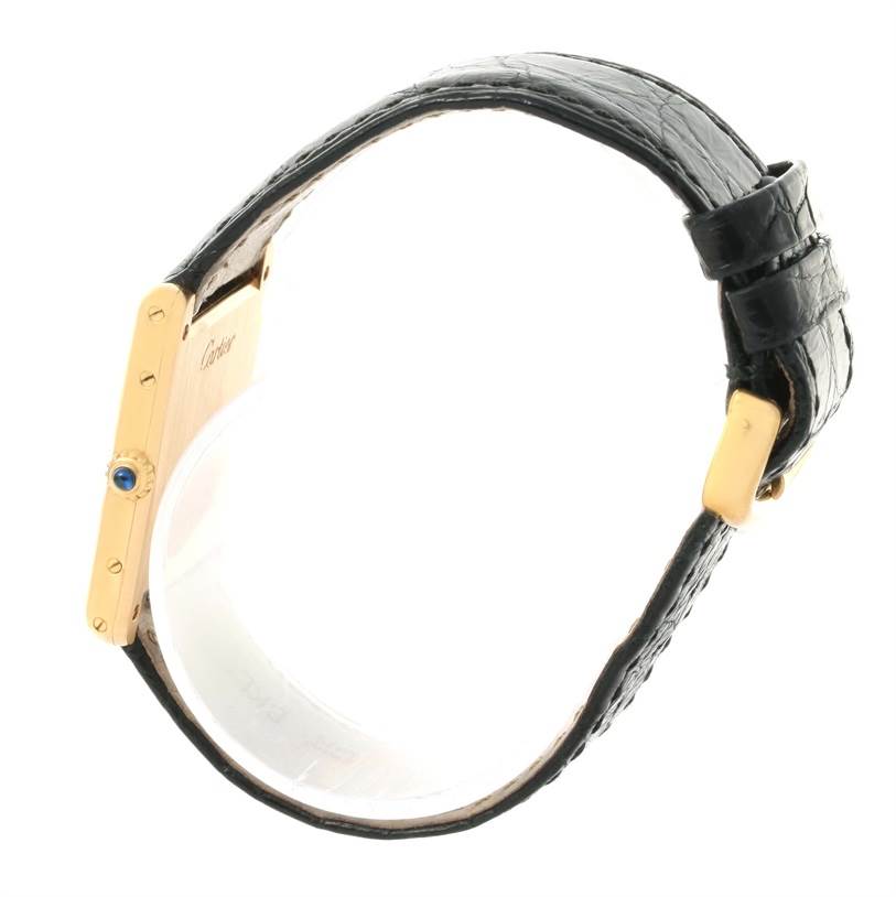 The image shows a side view of a Tank Classic watch by Cartier, displaying the case, crown with a blue cabochon, and leather strap.