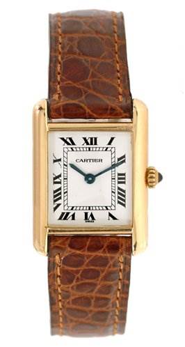 The image shows a front view of the Cartier Tank Classic Women's Yellow Gold White Dial Women's Yellow Gold White Dial watch, displaying its rectangular face, Roman numerals, and brown leather strap.