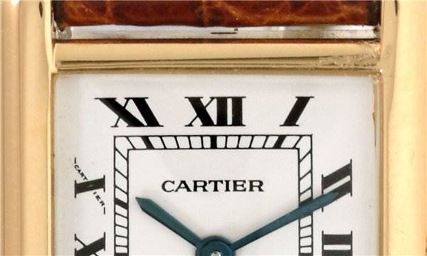 This image shows the upper part of the Cartier Tank Classic Women's Yellow Gold White Dial Women's Yellow Gold White Dial watch face, including the Roman numerals and the brand name.
