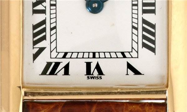 The image shows a close-up of the dial and part of the strap of a Cartier Tank Classic Women's Yellow Gold White Dial Women's Yellow Gold White Dial watch, focusing on the lower half with Roman numerals.