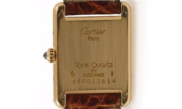 This image shows the back case of a Cartier Tank Quartz Classic watch, detailing the branding, model, and serial number.