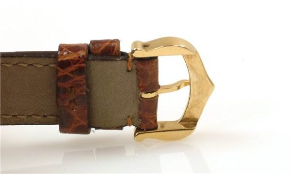 This image shows the leather strap and gold buckle of a Tank Classic model by Cartier from a side angle.