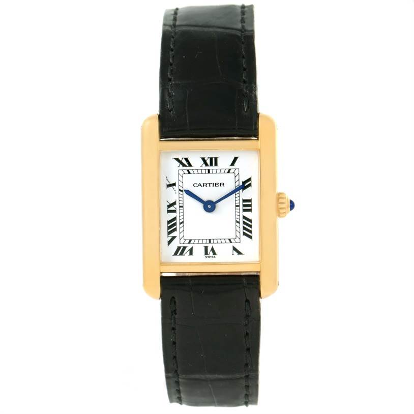 The image shows a Cartier Tank Classic Women's Yellow Gold White Dial Women's Yellow Gold White Dial watch with a rectangular gold case, white dial, Roman numerals, and a black leather strap.