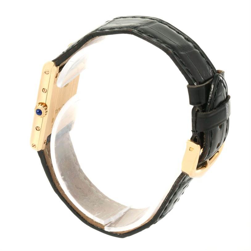 The image shows a side view of the Tank Classic watch by Cartier, highlighting the crown and black leather strap.