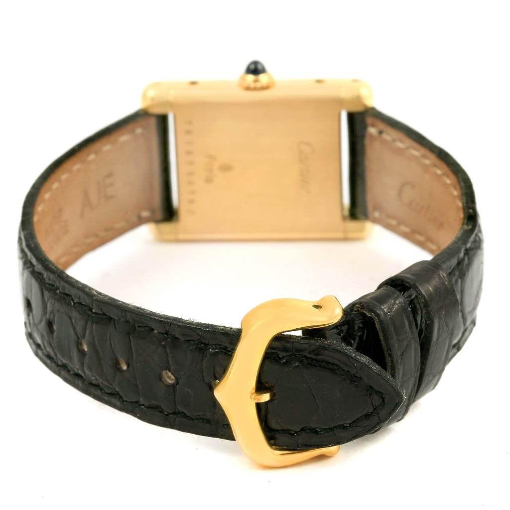 This image shows the back view of the Cartier Tank Classic Women's Yellow Gold White Dial Women's Yellow Gold White Dial model, featuring its leather strap and gold buckle.