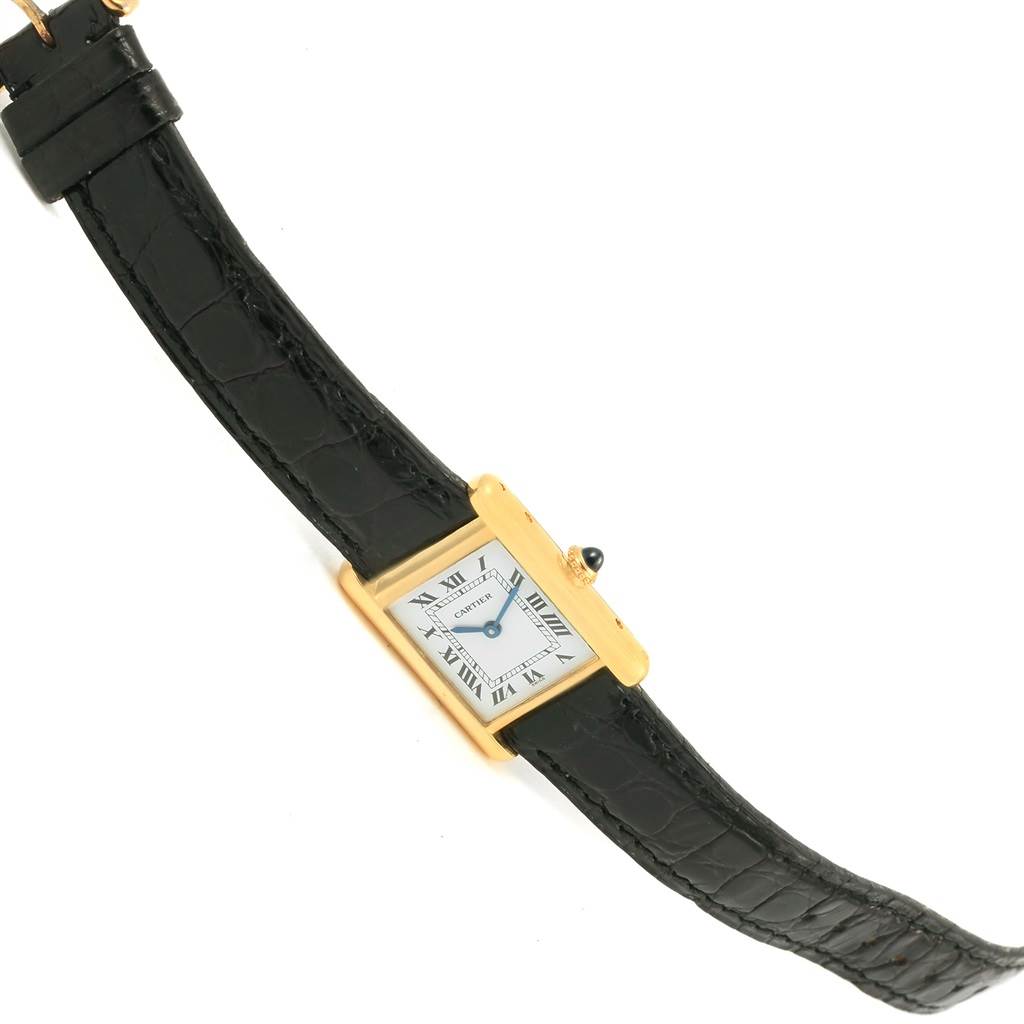 The image shows a Cartier Tank Classic Women's Yellow Gold White Dial Women's Yellow Gold White Dial watch with a rectangular face and black leather strap at a slight diagonal angle.