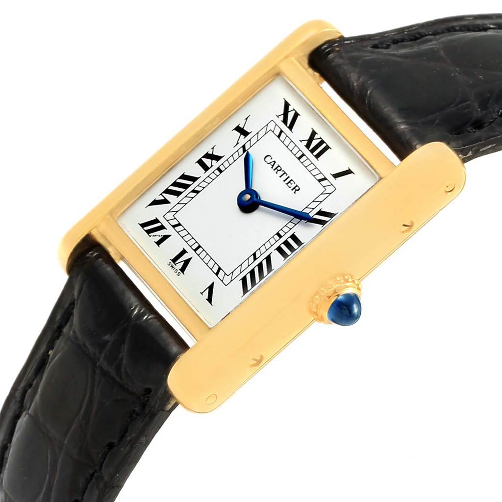 The Cartier Tank Classic Women's Yellow Gold White Dial Women's Yellow Gold White Dial watch is shown at an angled view highlighting its gold case, roman numeral dial, blue hands, and leather strap.
