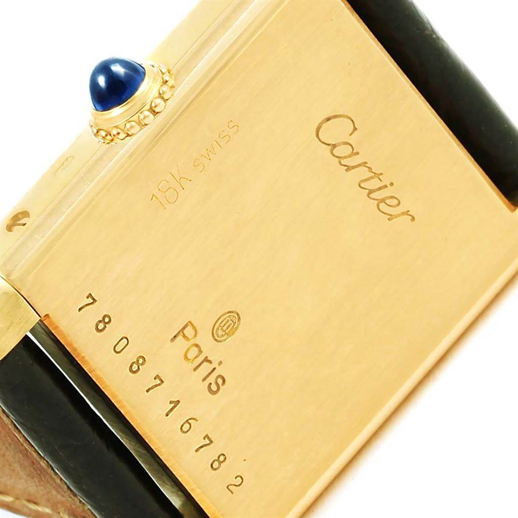 This image shows the back case and crown of the Cartier Tank Classic Women's Yellow Gold White Dial Women's Yellow Gold White Dial watch, highlighting the gold finish and engravings.