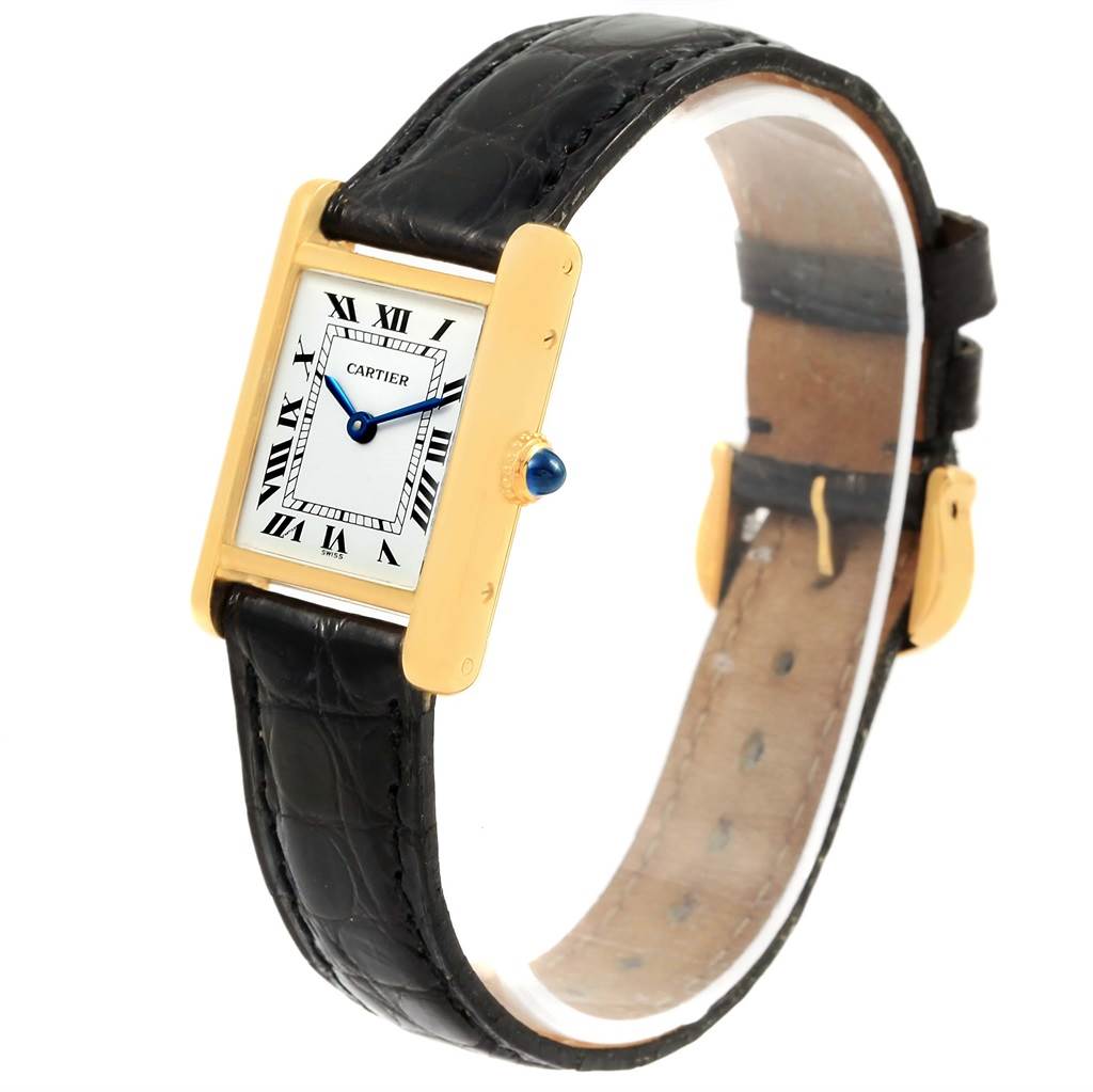 The Cartier Tank Classic Women's Yellow Gold White Dial Women's Yellow Gold White Dial watch is shown from a three-quarter angle, highlighting its face, case, leather strap, and clasp.