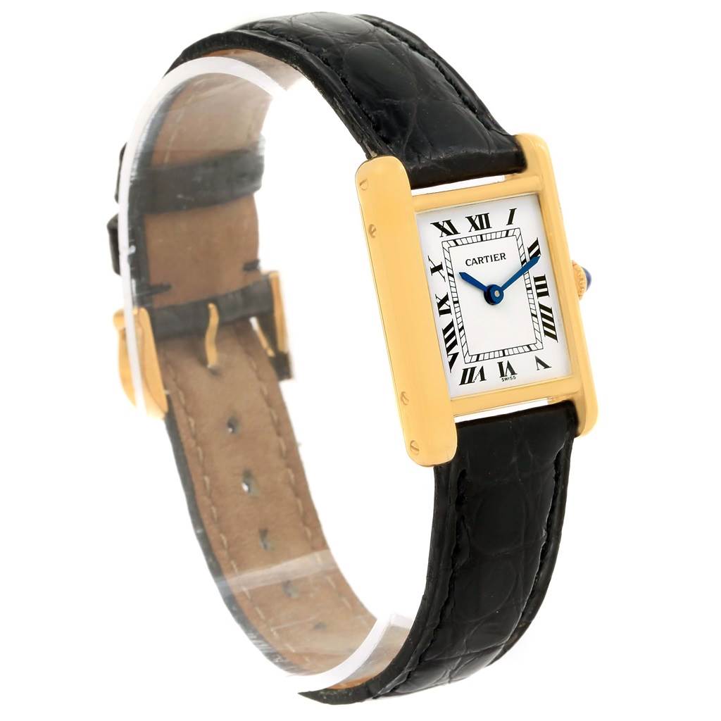 The image shows a side angle of the Cartier Tank Classic Women's Yellow Gold White Dial Women's Yellow Gold White Dial watch, displaying the face, black leather strap, and gold case.