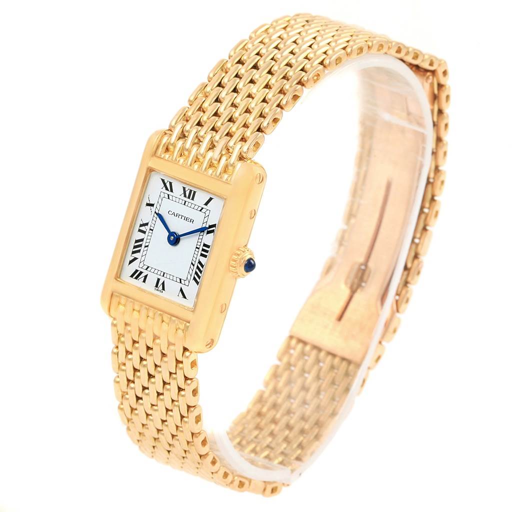 The image shows a Cartier Tank Classic Women's Yellow Gold White Dial Women's Yellow Gold White Dial watch at an angled view, highlighting its rectangular face, Roman numerals, and gold bracelet.