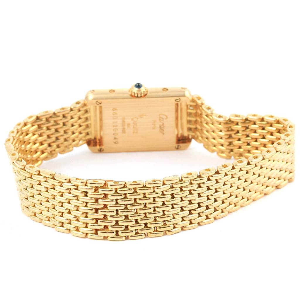 The image shows the back view of a Cartier Tank Classic Women's Yellow Gold White Dial Women's Yellow Gold White Dial watch, highlighting the gold case and woven bracelet.