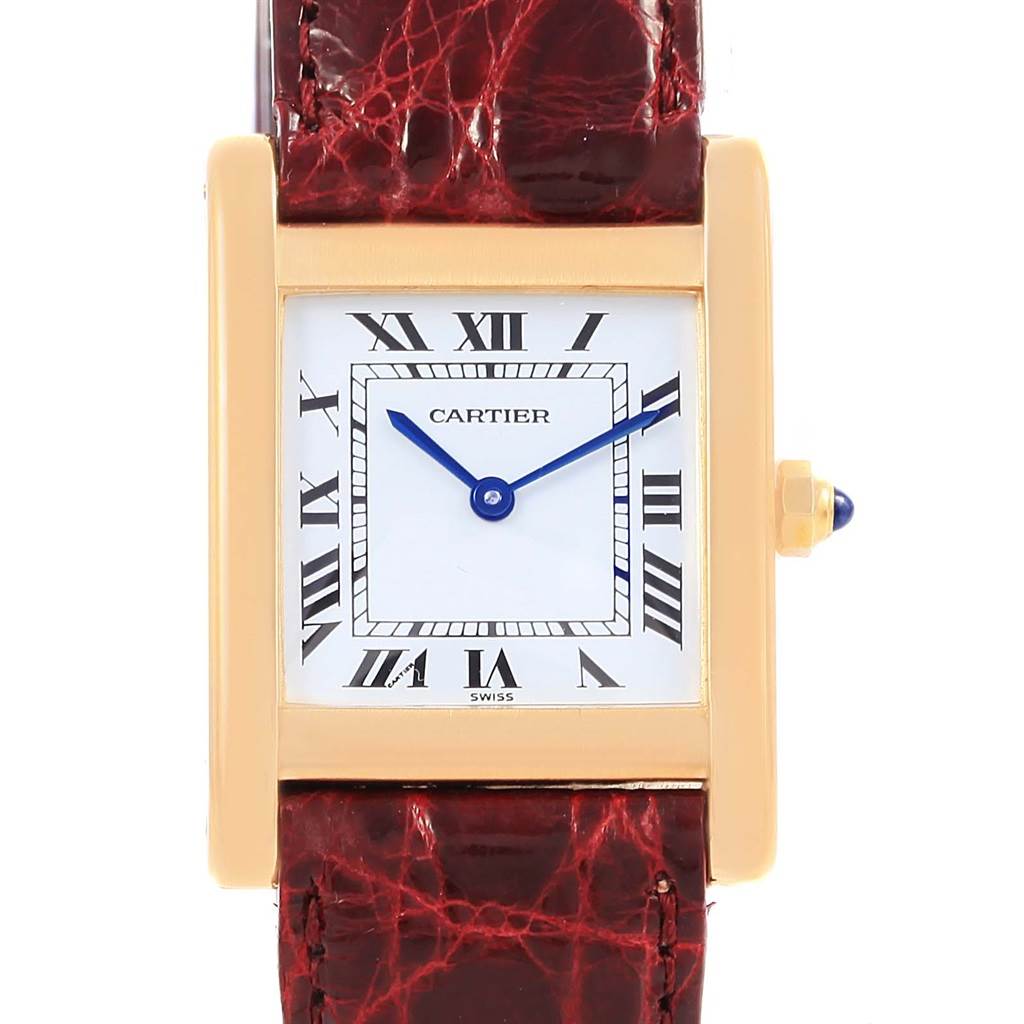 This image shows a front view of the face and a portion of the strap of a Cartier Tank Classic Women's Yellow Gold White Dial Women's Yellow Gold White Dial watch.