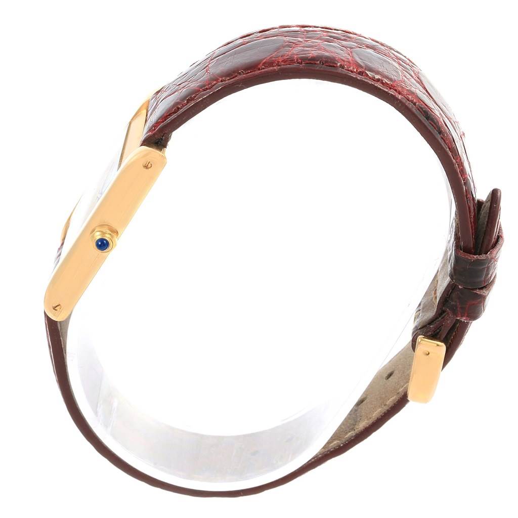 This image shows the side view of a Cartier Tank Classic Women's Yellow Gold White Dial Women's Yellow Gold White Dial watch, focusing on the case, crown, and leather strap.